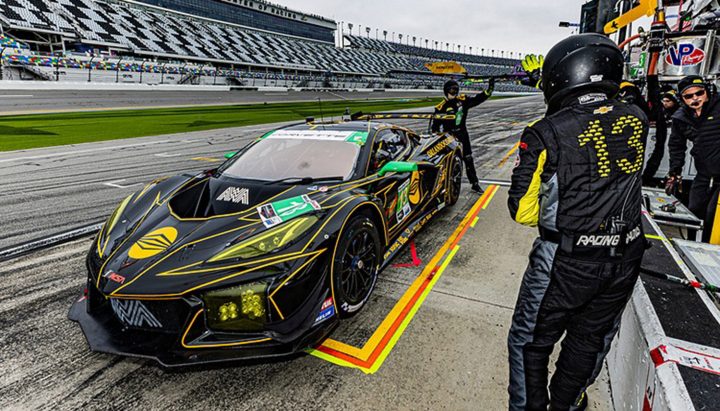 Photo of the No. 13 Corvette Racing Z06 GT3.R on track at Daytona, shown from a front three-quarters angle. This race car has been retired after winning the Rolex 24. 