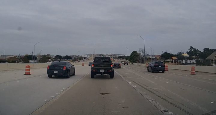 A Cadillac CT4 tries to merge back onto a busy highway.