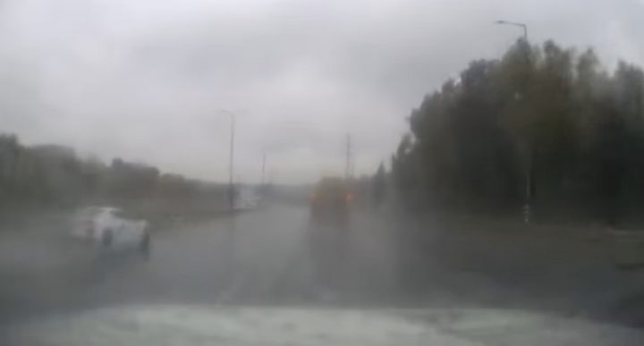 A C8 Corvette on a rainy highway.
