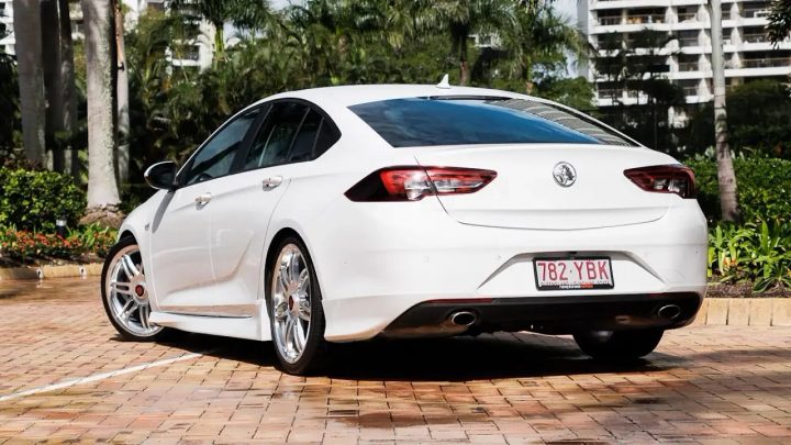 Photo of the Holden Commodore sold by Australian Supercars team Triple Eight, shown from a rear three-quarters angle. The vehicle features a racing-inspired bodykit. 