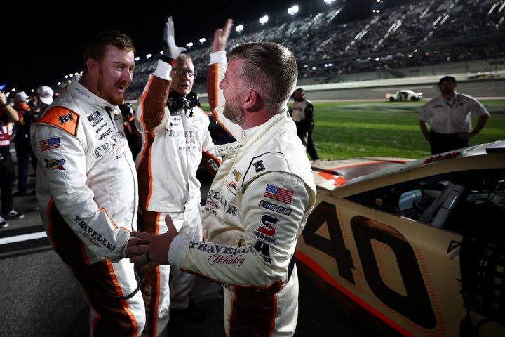 Photo of NASCAR Chevy driver Justin Allgaier celebrating with his team after racing his way into the 2025 Daytona 500. Allgaier was the highest-finishing non-chartered team in Duel 1.