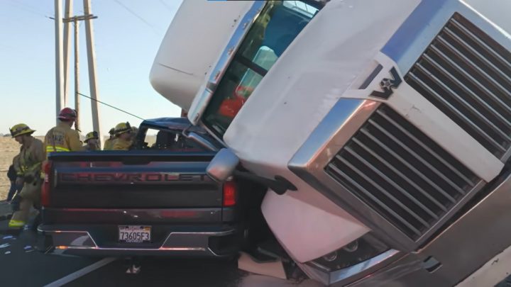 Chevy Silverado smashed by semi truck.