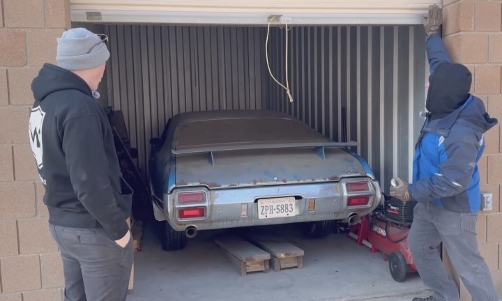 A classic 1971 Oldsmobile 442 is revealed in a storage unit.