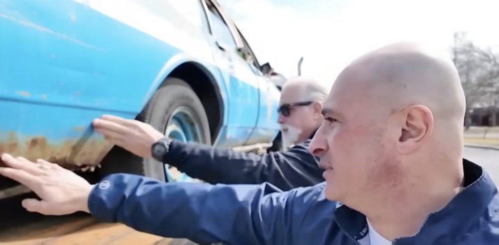 Retired NYPD members look over a 1987 Chevy Caprice police vehicle.