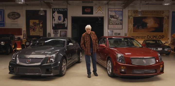 Jay Leno stands in front of a first-gen Cadillac CTS-V performance sedan.