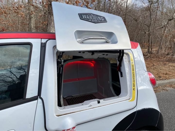 Chevy Spark based Domino's DXP warming oven open.