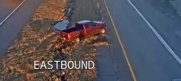Chevy Silverado gets stuck in mud on the side of the freeway.