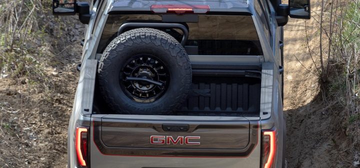 GMC Sierra HD with an aftermarket vertical spare tire mount.