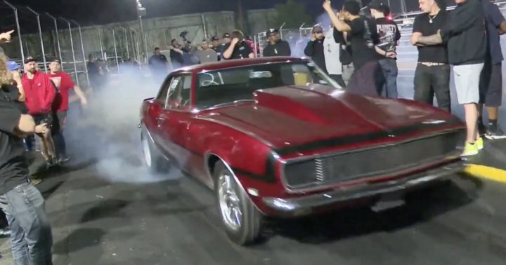Chevy Camaro does a burnout for a drag race.