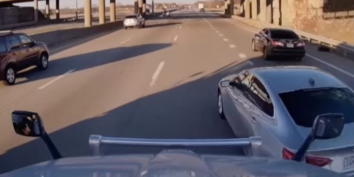 Chevy Malibu merges into a semi truck.