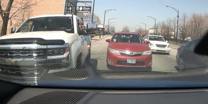 Chevy Silverado driver glares at a red Toyota.