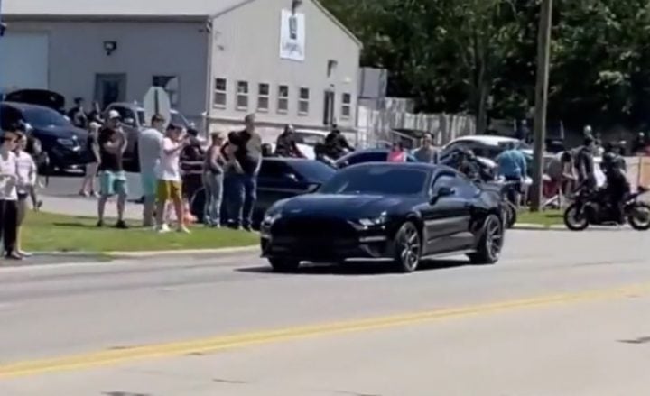 Ford Mustang prepares to burnout before crashing into a C6 Corvette.
