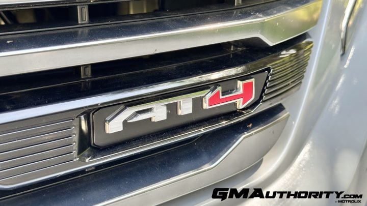 A chrome AT4 badge on the grille a 2025 GMC Sierra AT4.