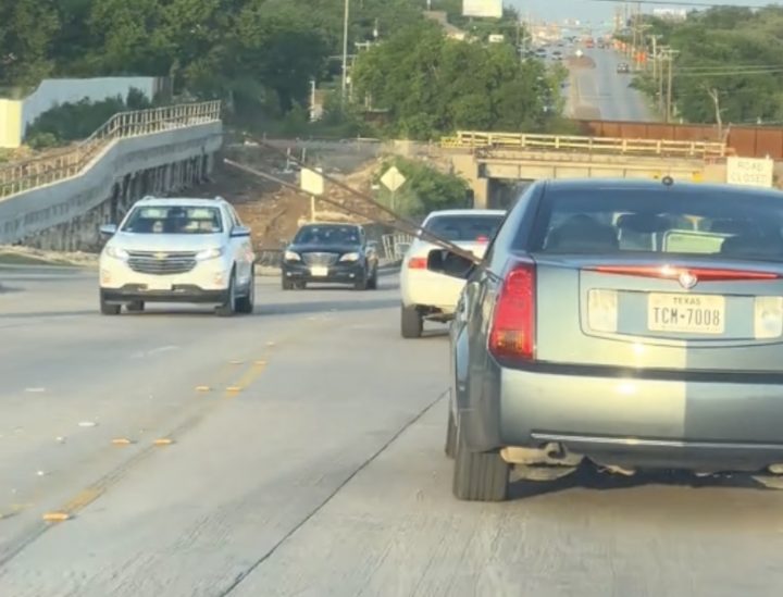 Cadillac CTS with rods of rebar sticking out the window.