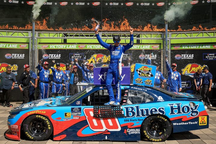 Photo of Kyle Larson in Victory Lane, standing on the window of the No. 88 NASCAR Chevy. Larson subbed in the No. 88 Chevy for Connor Zilisch at Texas. 