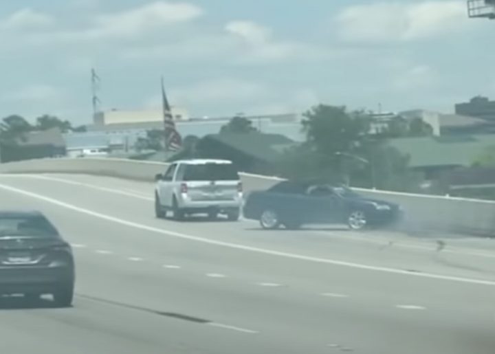 Saab 9-3 swings wildly back and forth on the freeway.