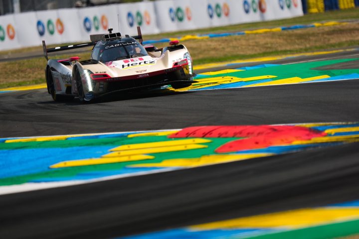 Photo of one of the Cadillac Hertz Team JOTA race cars on track at Le Mans, shown from a front angle as it takes chicanes. Cadillac Racing had mixed results in the 2025 running of the event.