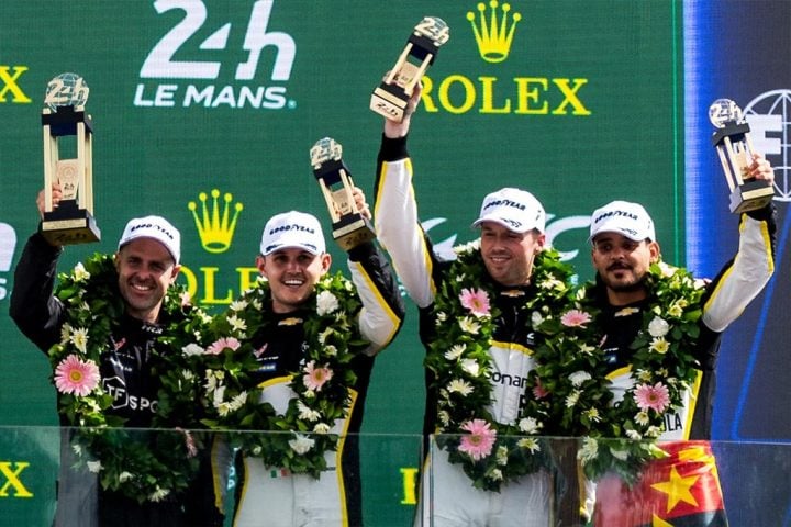 Photo of the TF Sport Corvette Racing team celebrating their LMGT3 podium after the 2025 24 Hours of Le Mans. 