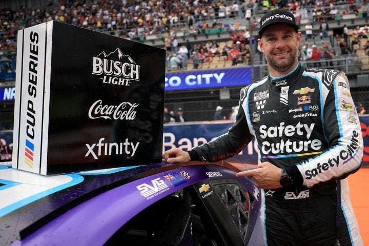 NASCAR Chevy driver Shane Van Gisbergen poses with his winning race car in Mexico City after winning the Cup Series' first point-paying race held outside the U.S. 