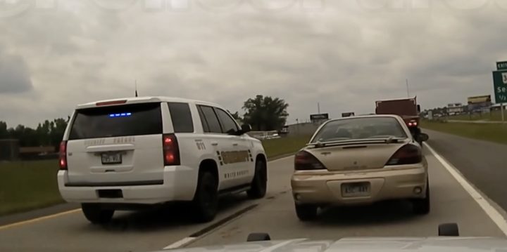A Pontiac Grand Am is boxed in by police.