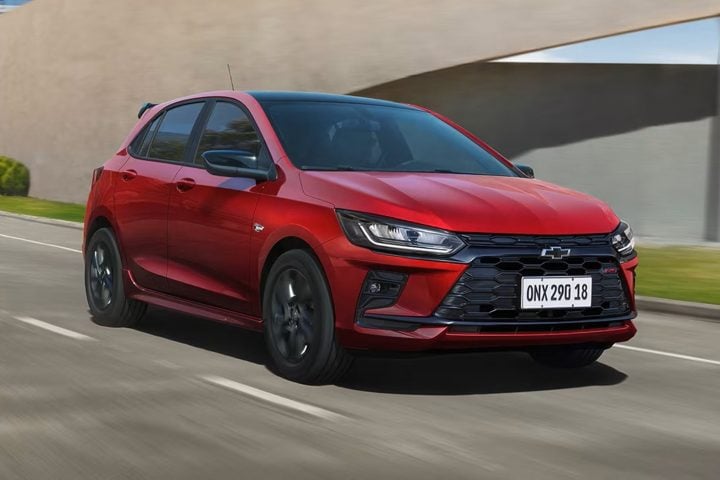 Front three-quarter view of the 2026 Chevy Onix RS hatchback made in Brazil.