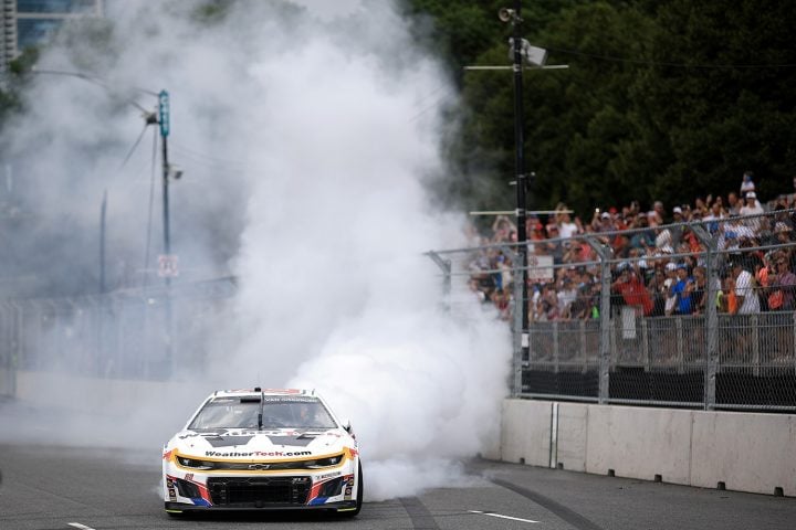 Photo of Shane van Gisbergen doing a burnout in his NASCAR Chevy after winning the Cup Series race at Chicago on July 6th, 2025.